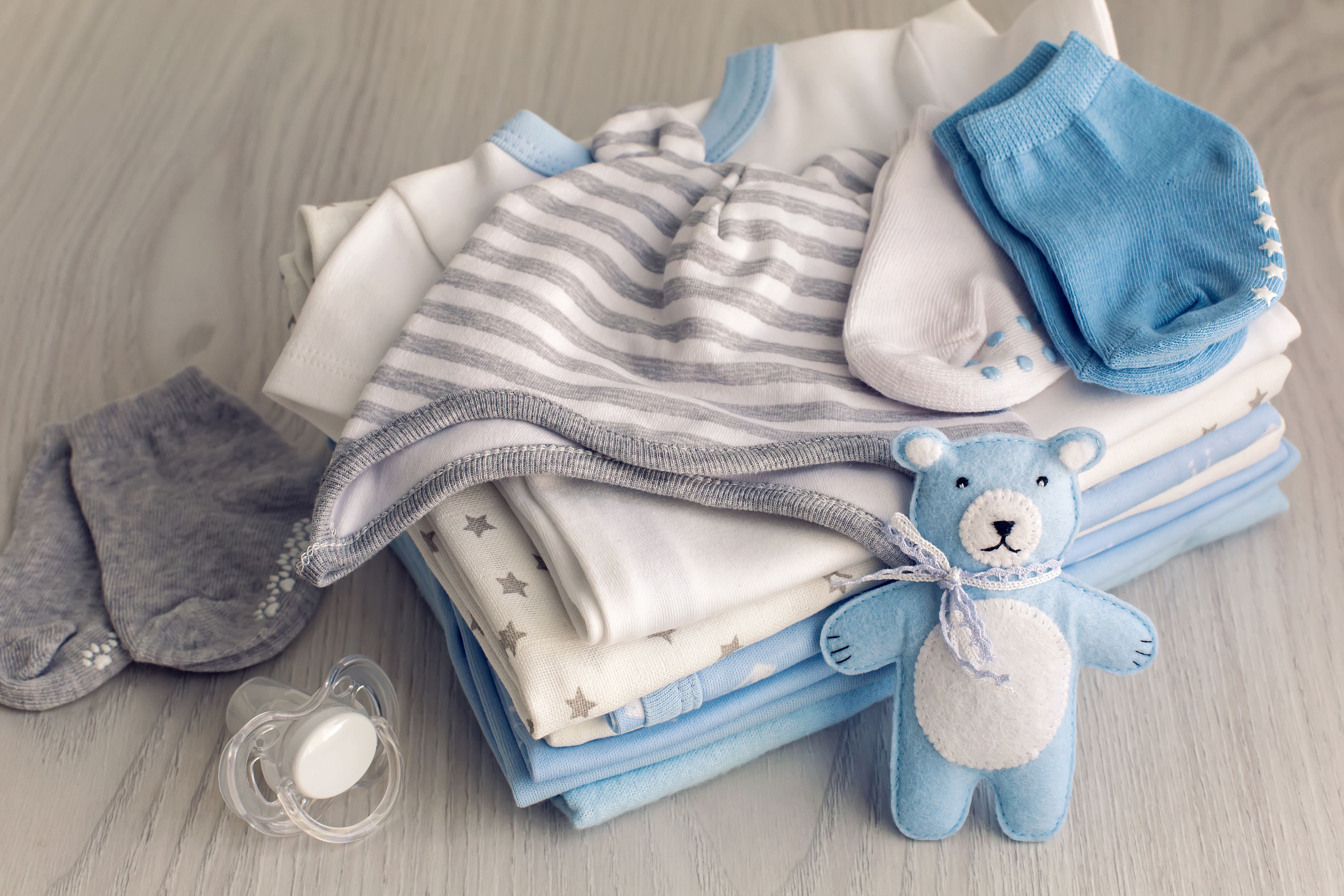 Stack of baby clothing and toys.jpg