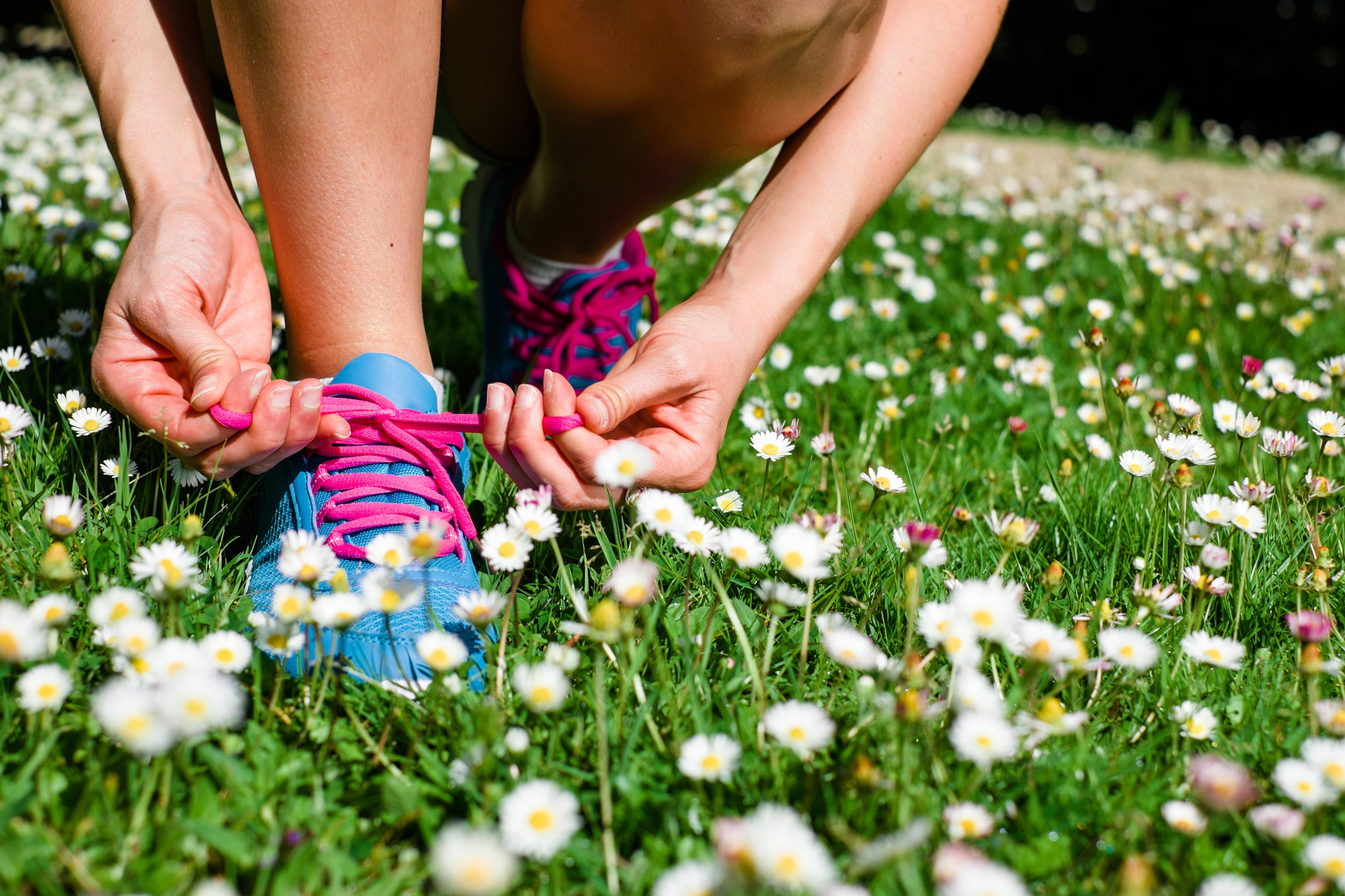 Taking care of shoes in the spring flowers grass.jpg