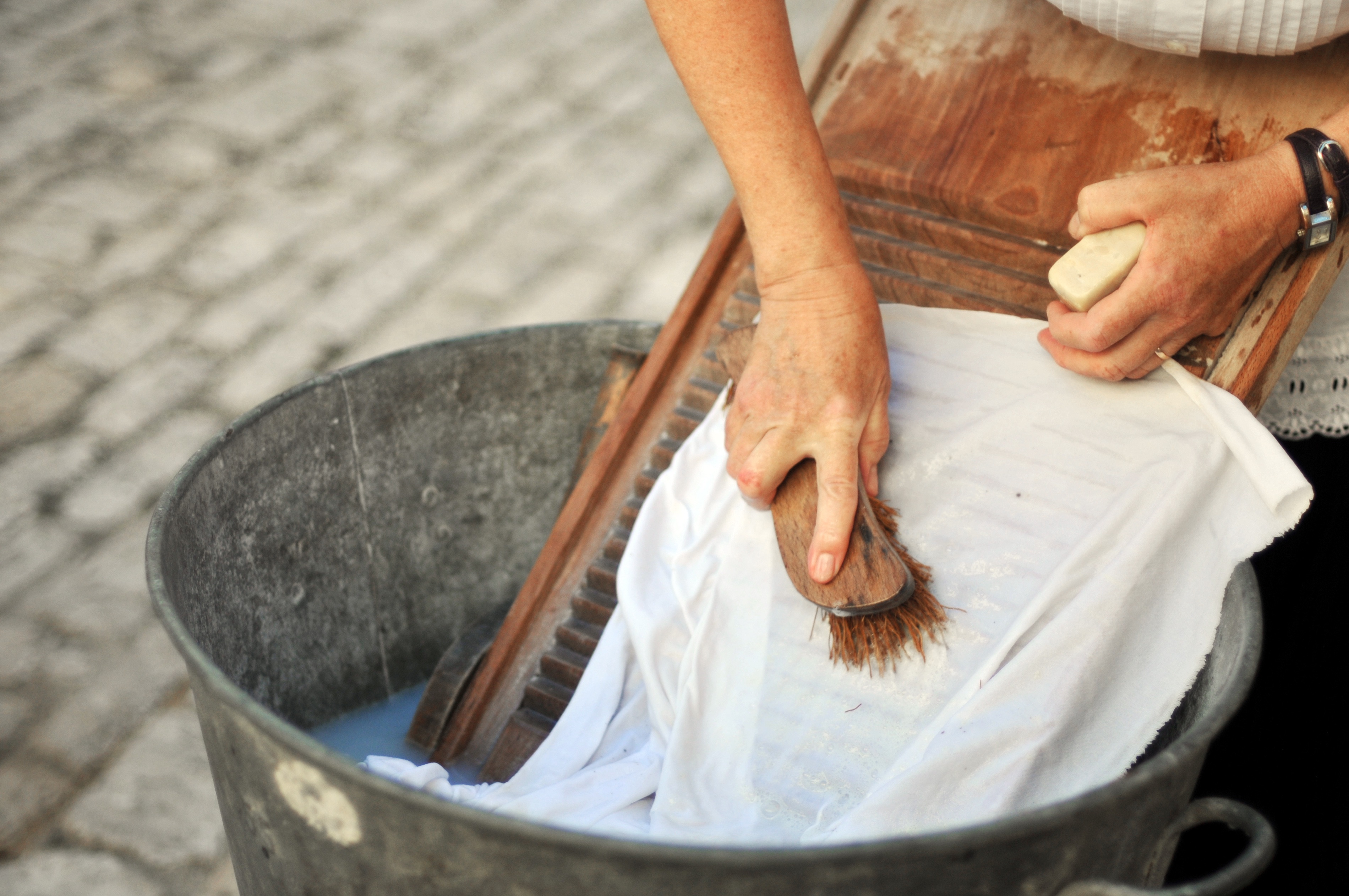 Washing clothes by hand in tub.jpg