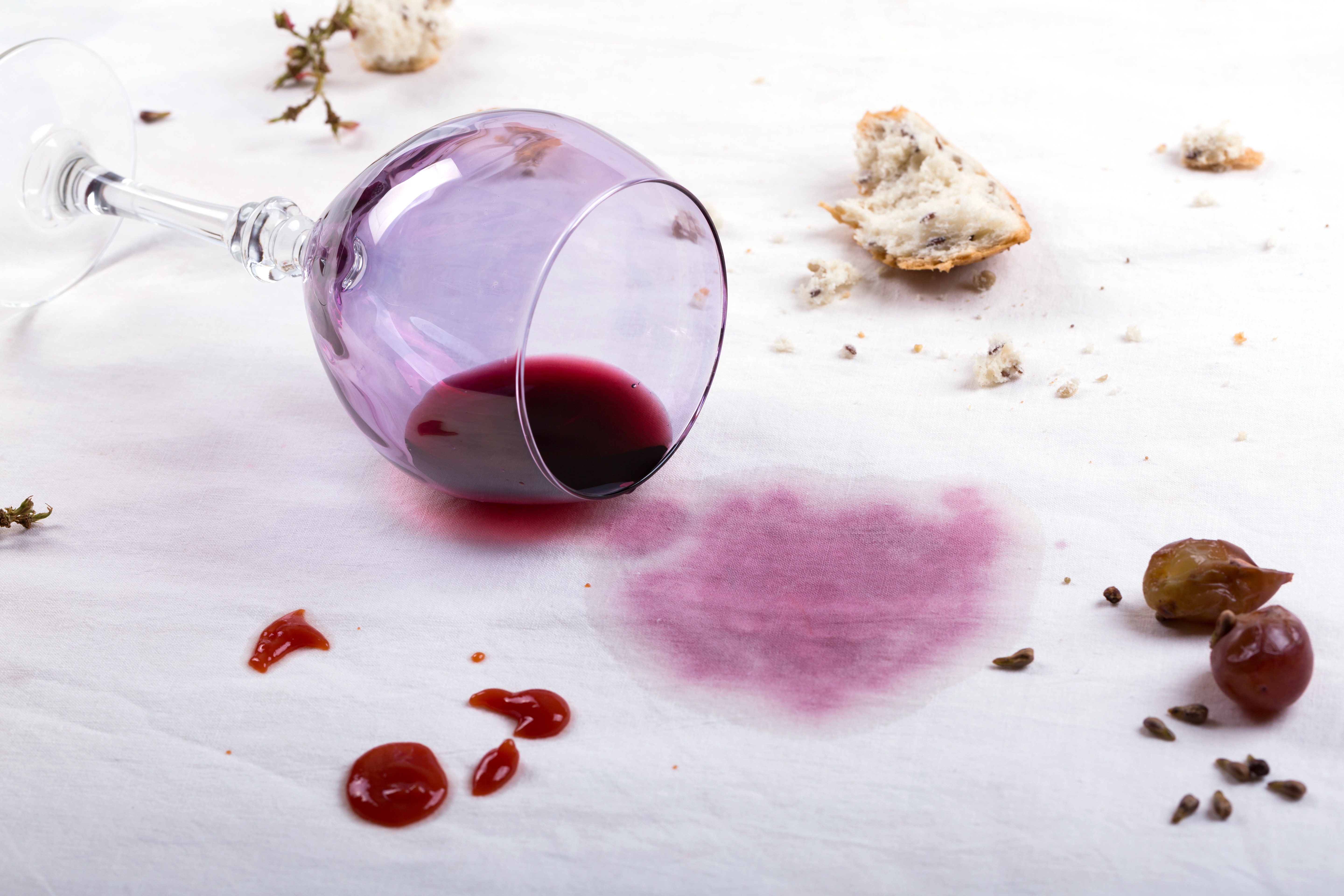 Wine glass dropped on white sheet and wine spilled over.jpg