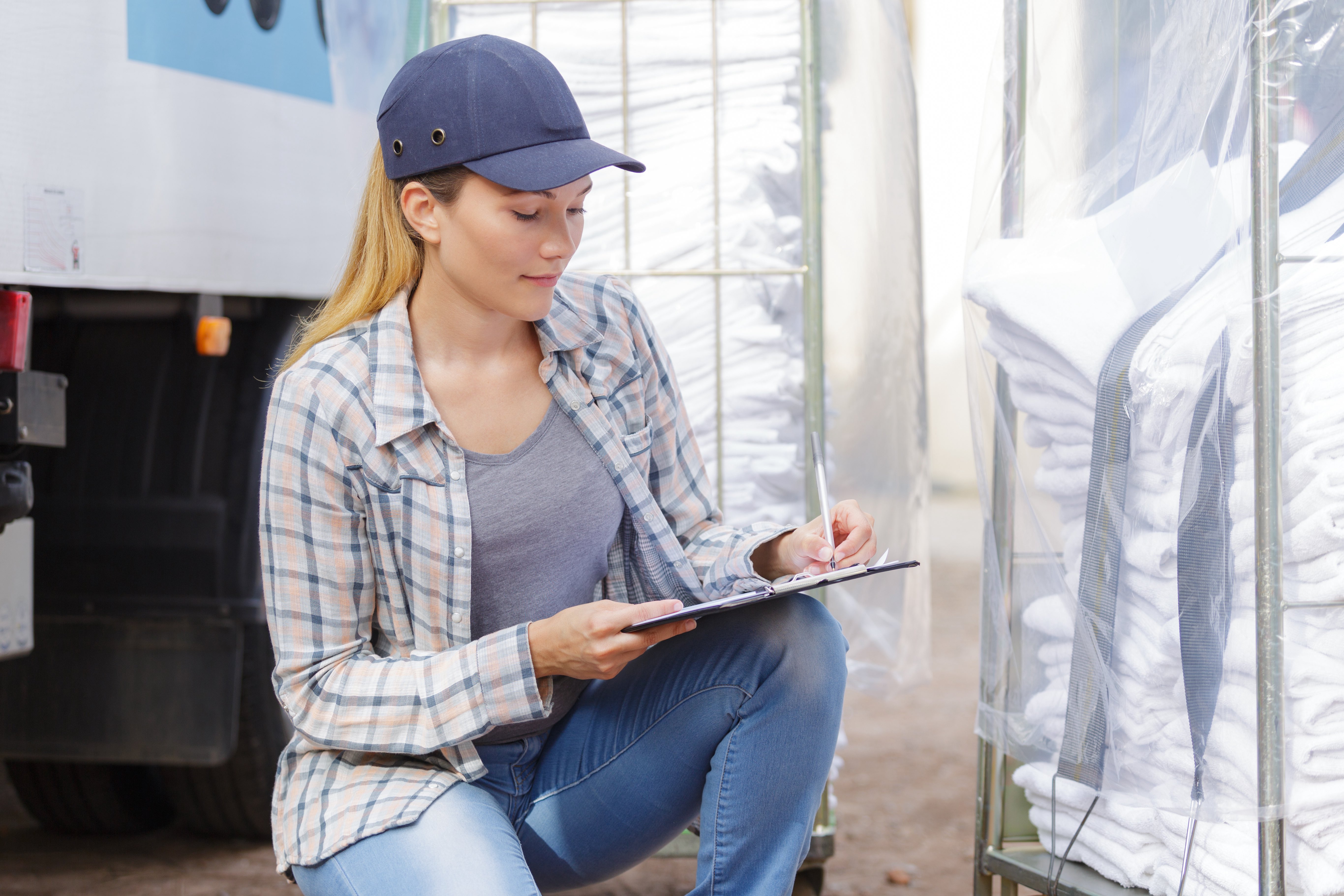 Woman delivering laundry and writing on board.jpg